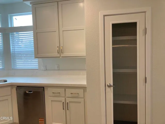 a view of kitchen with microwave and refrigerator