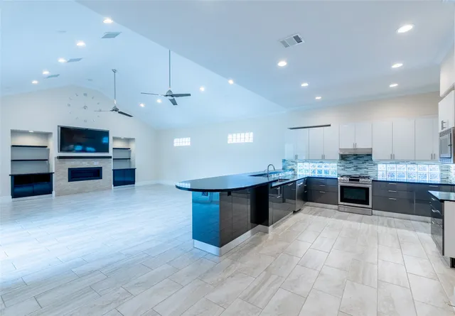 a view of kitchen with wooden floor and electronic appliances