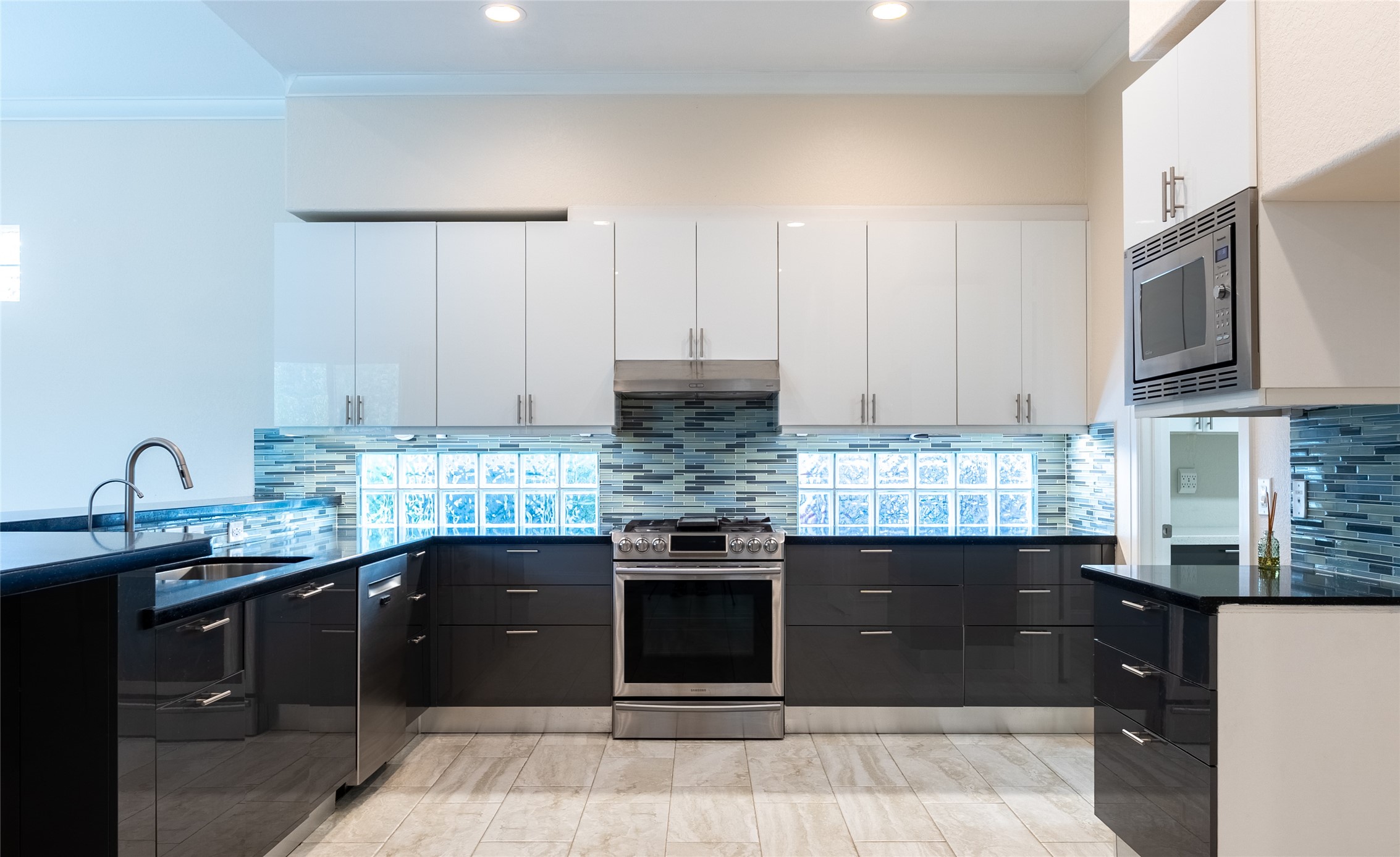 25718 Muirfield Bend Court Spring, TX 77389 - Photo 16 of 50 a kitchen with stainless steel appliances granite countertop a stove a sink and a microwave