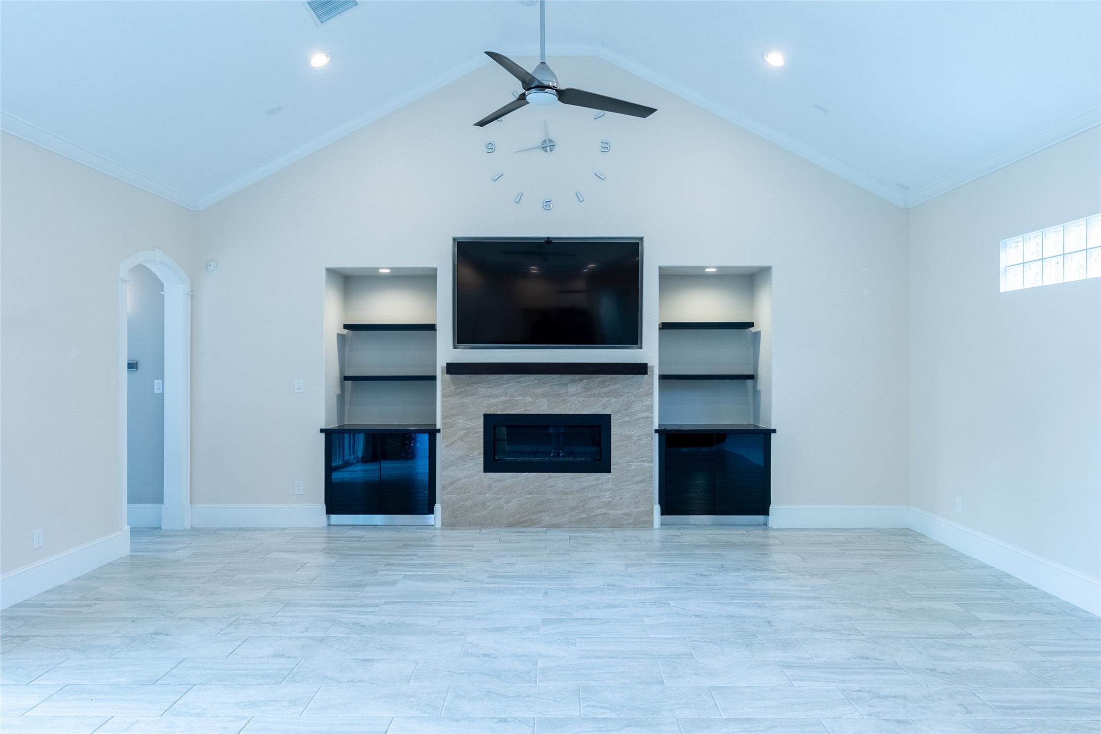 25718 Muirfield Bend Court Spring, TX 77389 - Photo 18 of 50 a living room with a fireplace and a flat screen tv