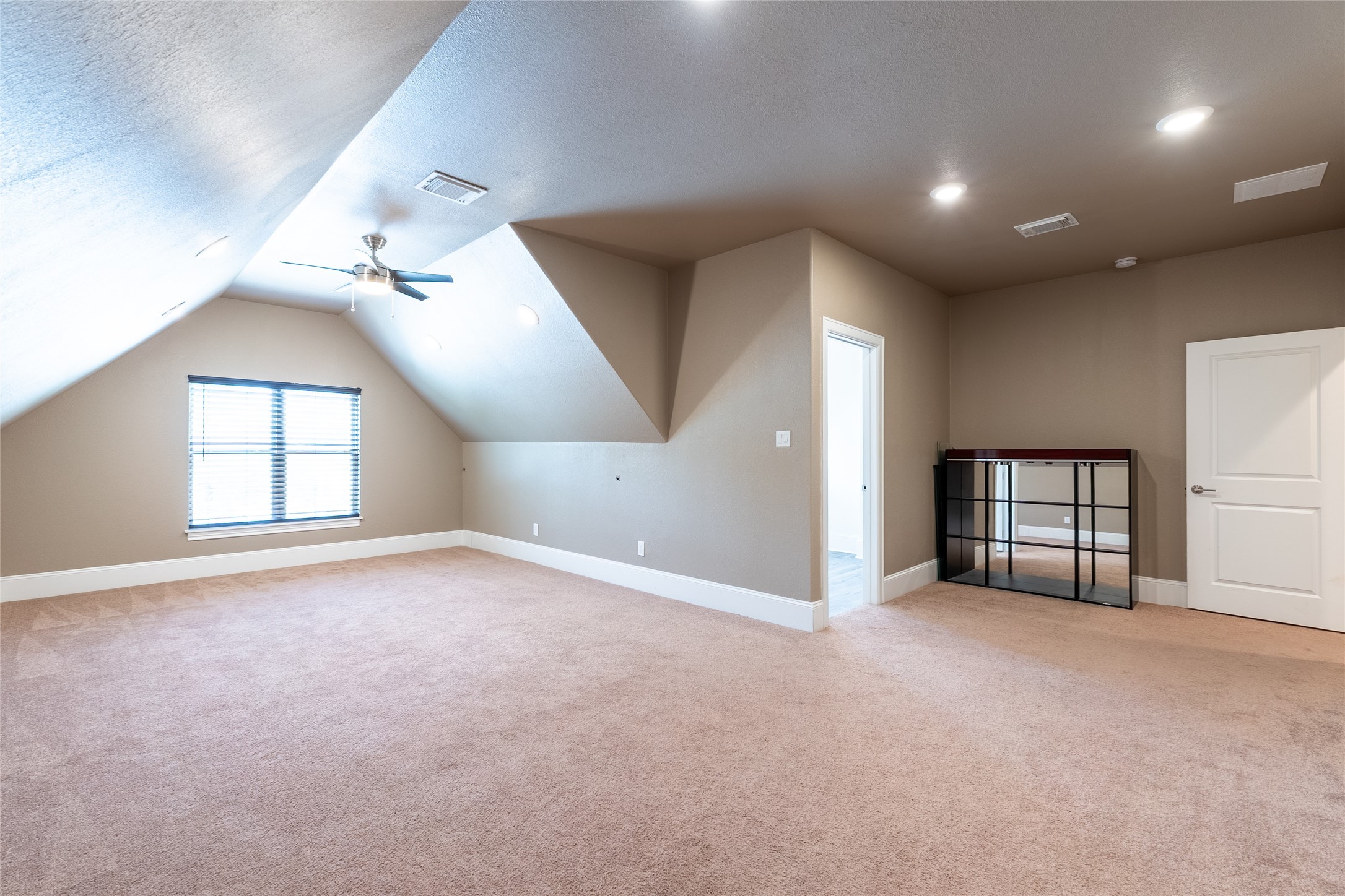 25718 Muirfield Bend Court Spring, TX 77389 - Photo 37 of 50 an empty room with windows and chandelier fan