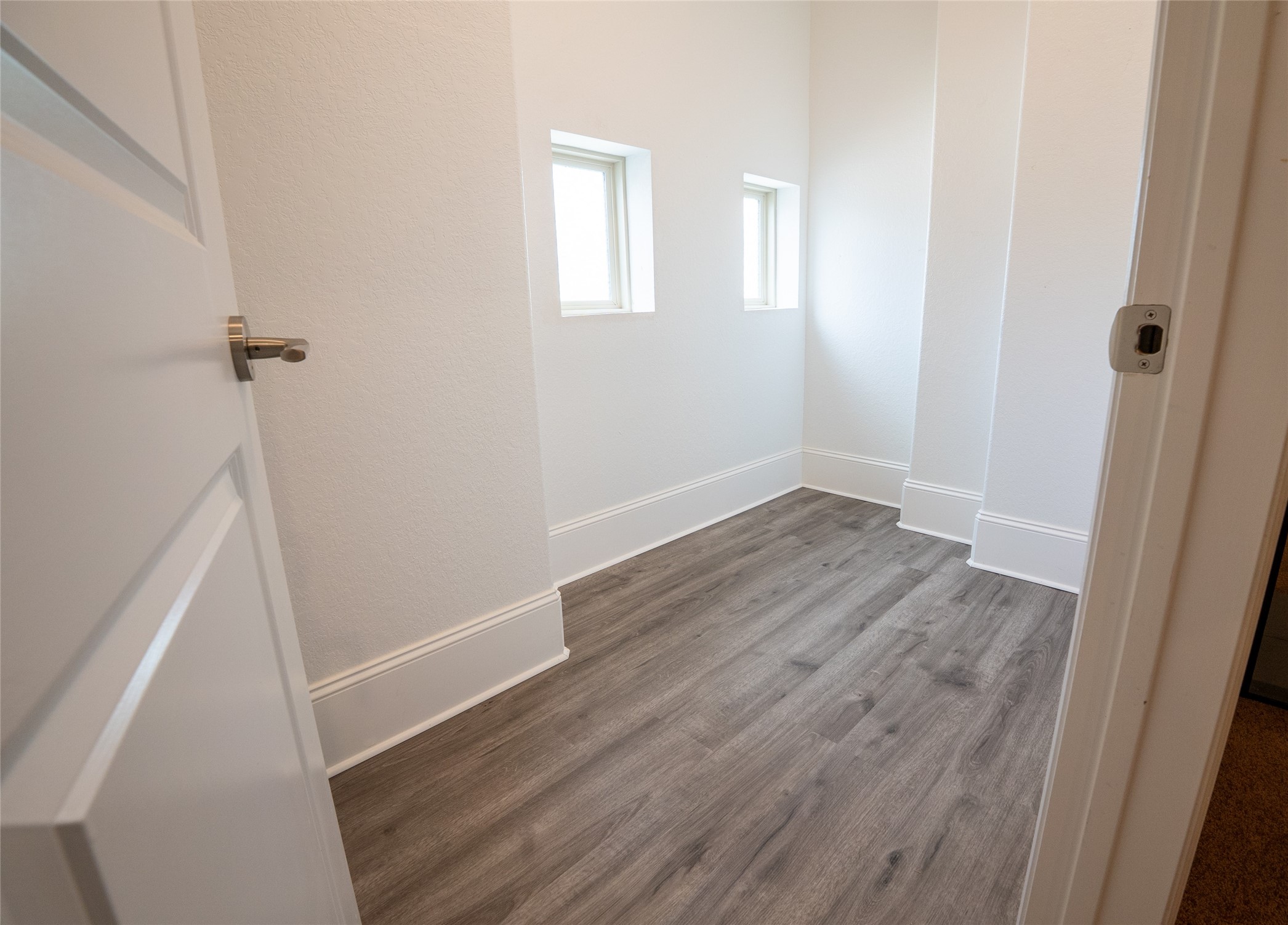 25718 Muirfield Bend Court Spring, TX 77389 - Photo 39 of 50 an empty room with wooden floor and white walls