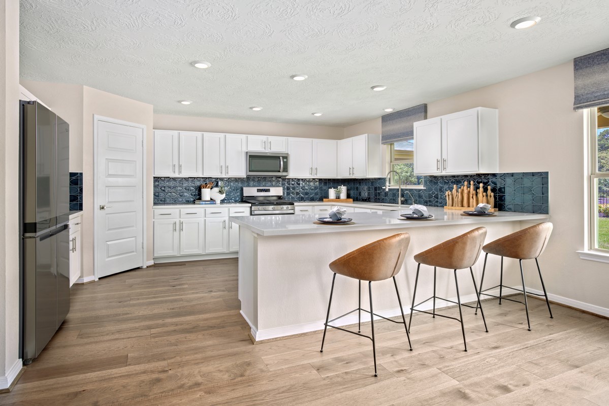 4751 Sprout Crk Court Conroe, TX 77304 - Photo 3 of 11 a kitchen with stainless steel appliances kitchen island granite countertop a refrigerator and a stove top oven