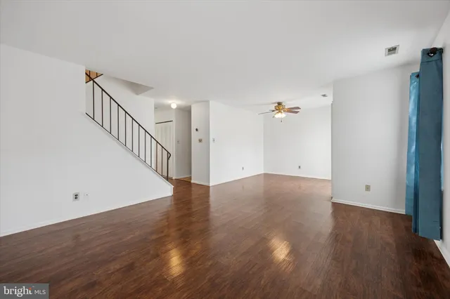 a view of a room with wooden floor