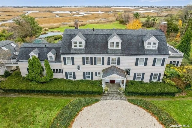 an aerial view of residential houses with outdoor space and river