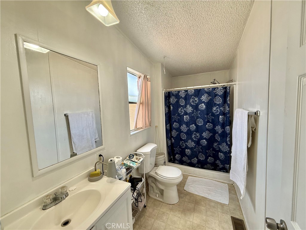 22020 Nisqually Road, Unit 65 Apple Valley, CA 92308 - Photo 13 of 14 a bathroom with a sink toilet and shower