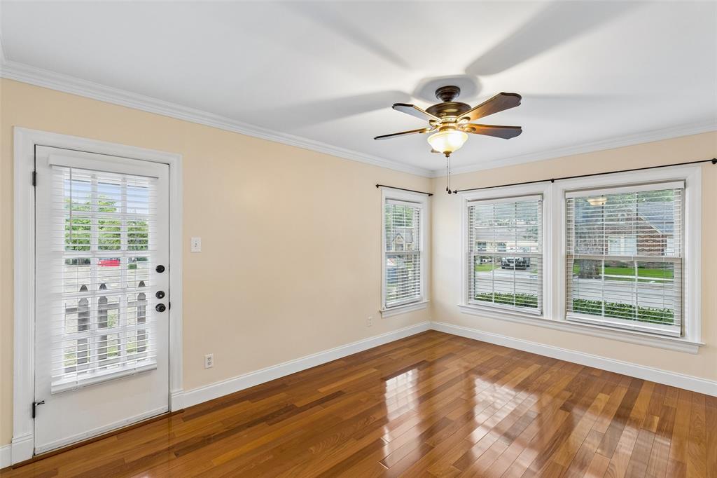 2427 Alco Avenue Dallas, TX 75211 - Photo 17 of 26 a view of a livingroom with a window and a ceiling fan