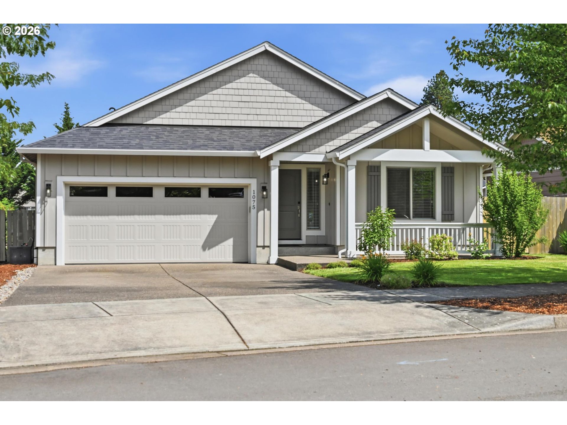 1075 Sage Street Silverton, OR 97381 - Photo 1 of 46 a front view of a house with a yard and potted plants