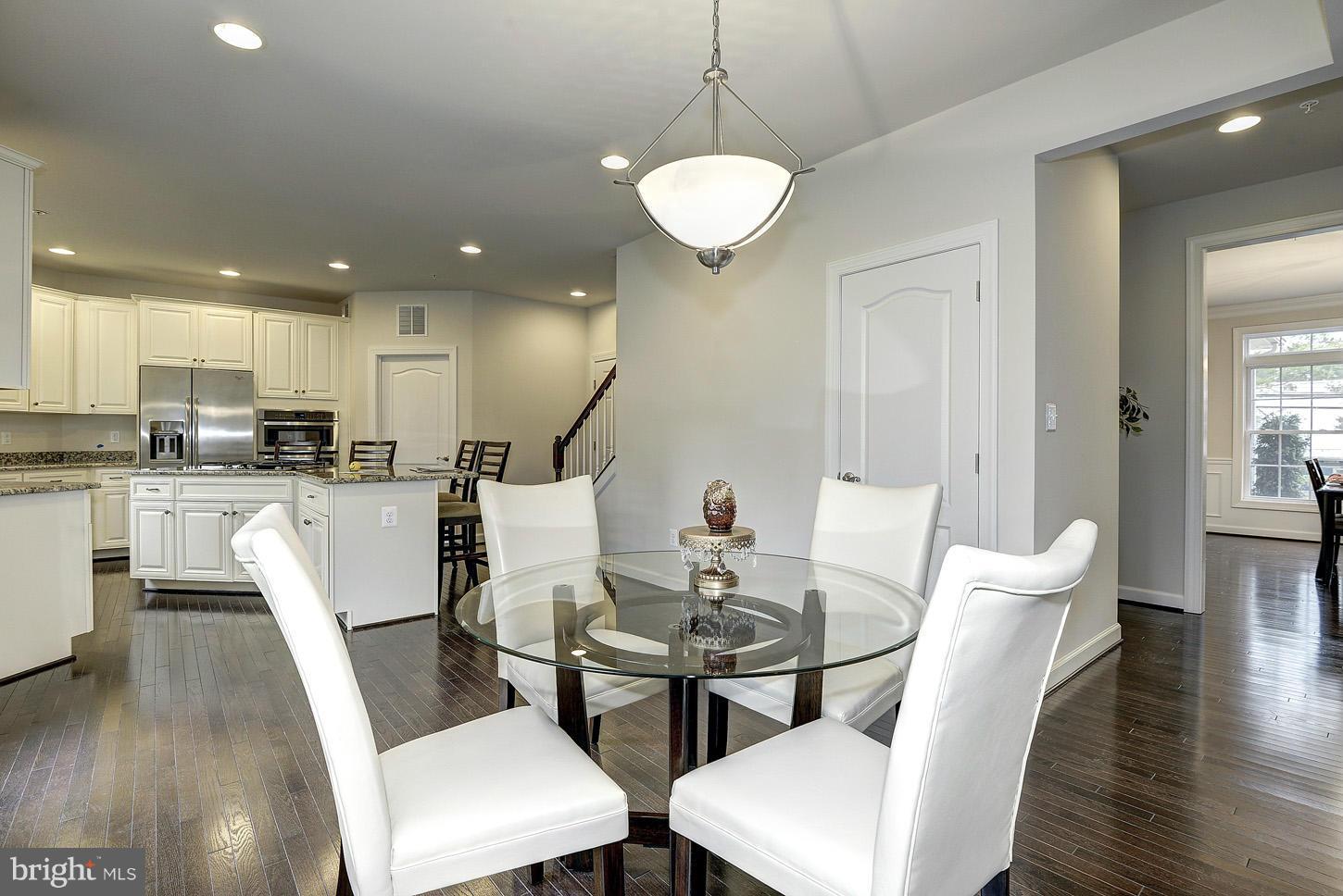 4125 Briars Road Olney, MD 20832 - Photo 8 of 29 a view of a dining room with furniture and wooden floor