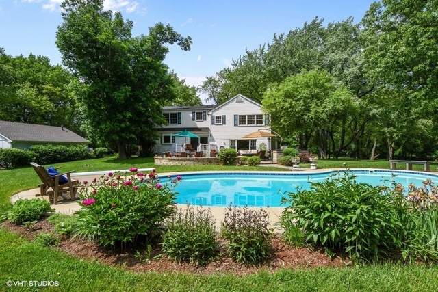 1719 Spring Creek Road Barrington Hills, IL 60010 - Photo 11 of 26 a view of a house with a swimming pool and a yard