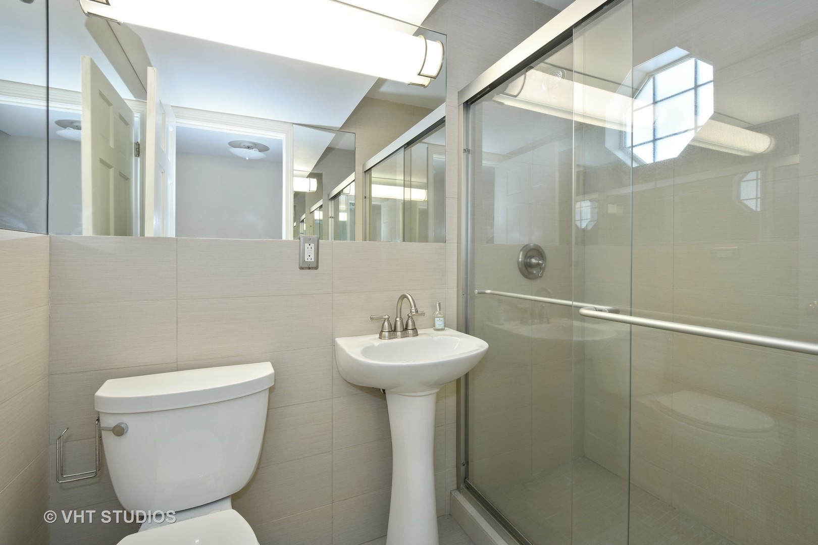 1719 Spring Creek Road Barrington Hills, IL 60010 - Photo 24 of 26 a bathroom with a sink mirror and toilet