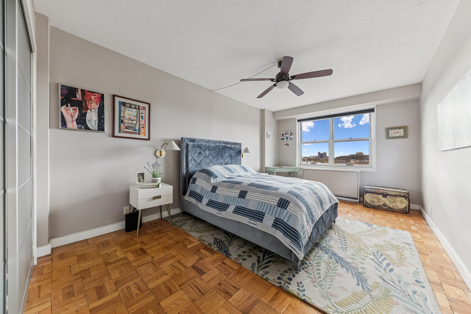 2400 Johnson Avenue, Unit 5F Bronx, NY 10463 - Photo 7 of 14 a bedroom with a bed and a chandelier