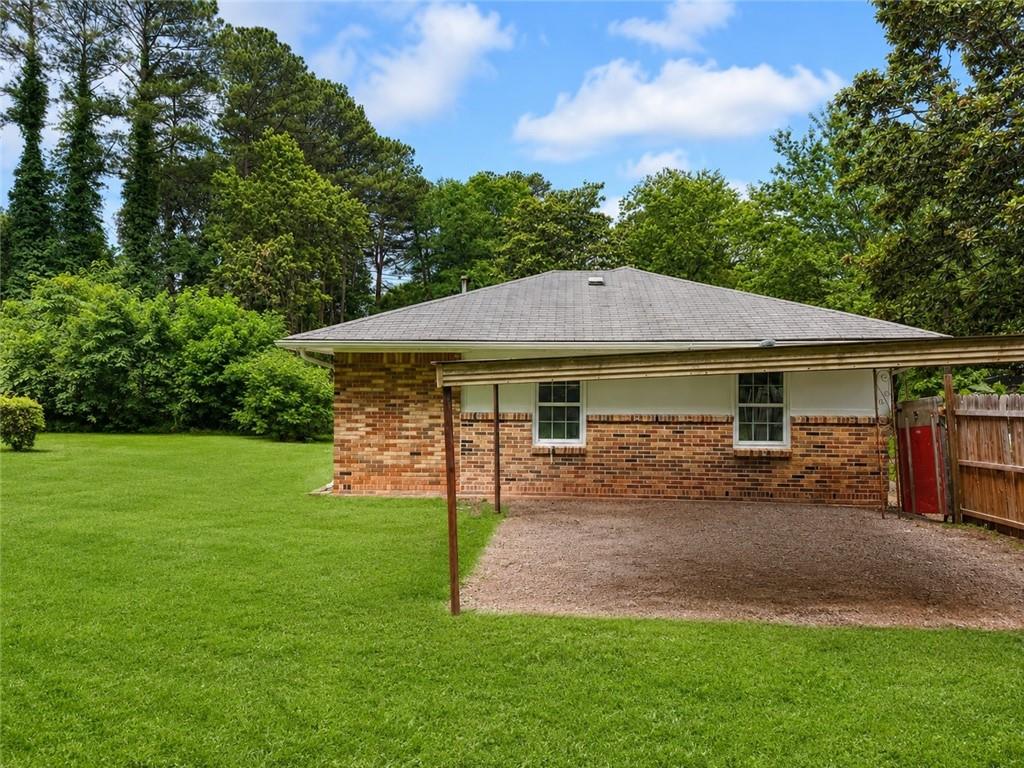 1189 Rock Cut Road Forest Park, GA 30297 - Photo 22 of 23 a view of a house with a yard and sitting area