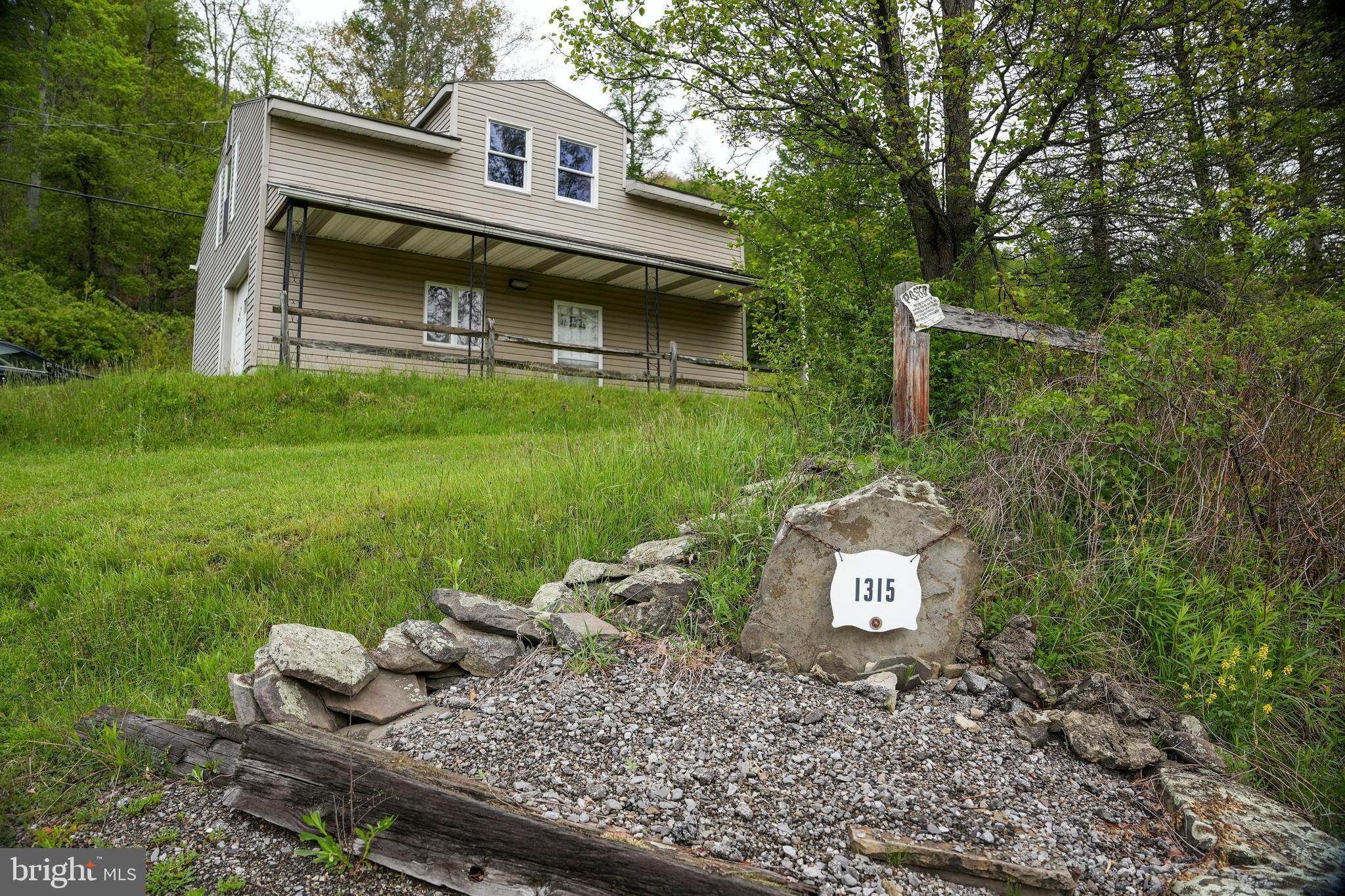 1315 1st Fork Road Austin, PA 16720 - Photo 6 of 25 a front view of a house with garden