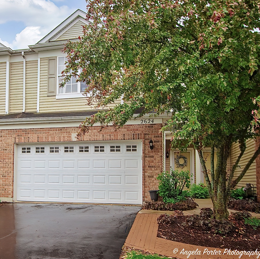 2624 Evergreen Circle McHenry, IL 60050 - Photo 1 of 18 a front view of a house with a yard