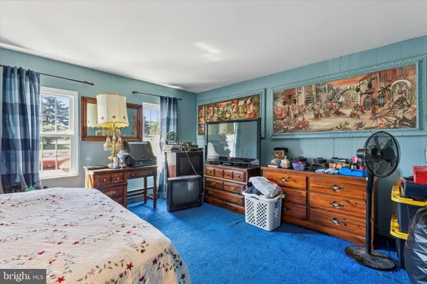 a bedroom with furniture and a window