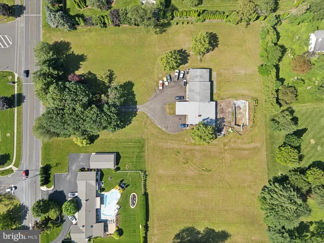 an aerial view of a residential building with garden space and swimming pool