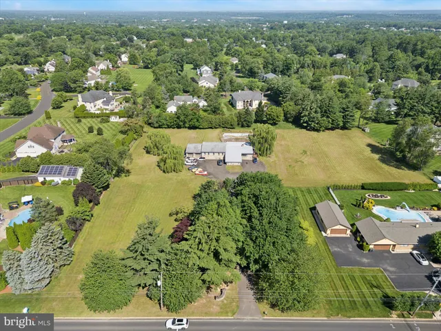 an aerial view of residential houses with outdoor space and swimming pool
