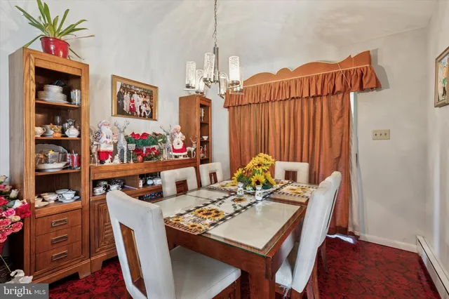 a view of a dining room with furniture and chandelier