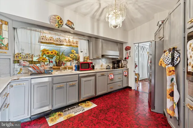 a kitchen with stainless steel appliances granite countertop a refrigerator and a stove top oven