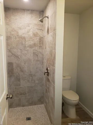 a bathroom with a toilet and a shower