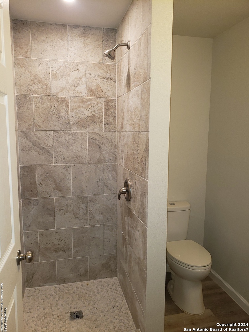 1912 14th Street, Unit 6 Hondo, TX 78861 - Photo 3 of 5 a bathroom with a toilet and a shower