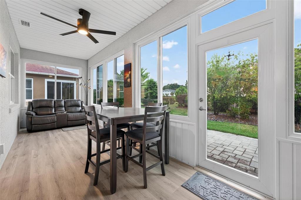 8336 Southwest 77th Court Ocala, FL 34476 - Photo 19 of 47 a dining room with furniture a chandelier and wooden floor