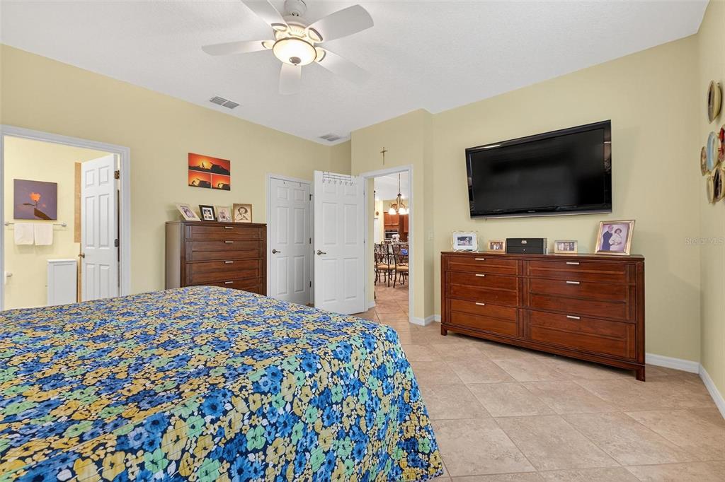 8336 Southwest 77th Court Ocala, FL 34476 - Photo 24 of 47 a large bedroom with a bed and flat screen tv