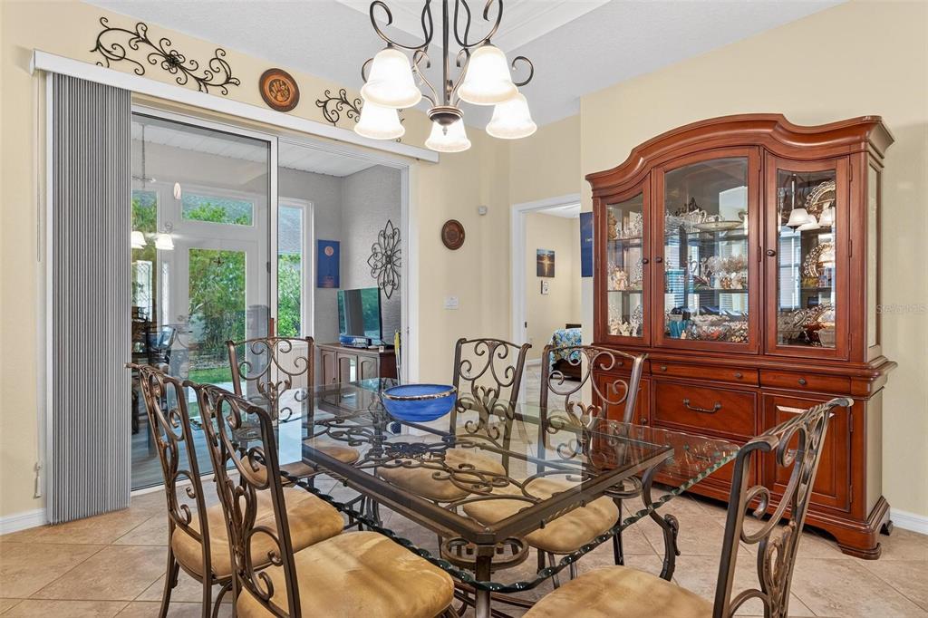 8336 Southwest 77th Court Ocala, FL 34476 - Photo 41 of 47 a view of a dining room with furniture wooden floor and chandelier