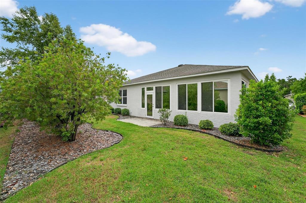 8336 Southwest 77th Court Ocala, FL 34476 - Photo 46 of 47 a view of a house with backyard sitting area and garden