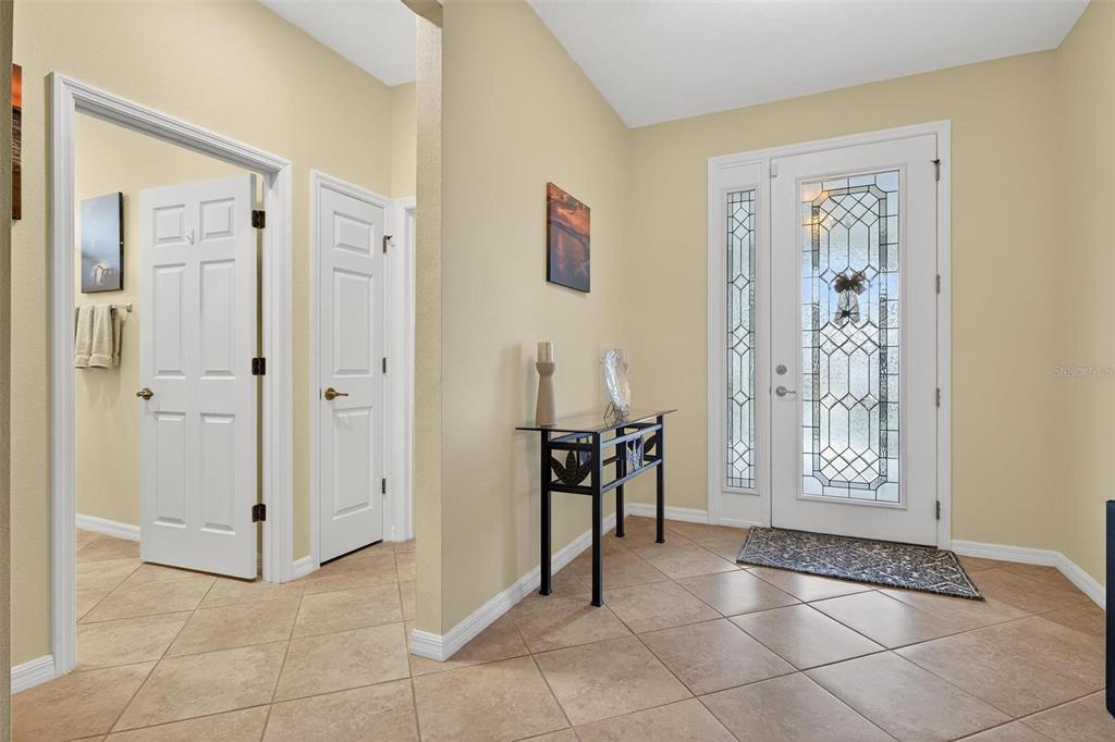 8336 Southwest 77th Court Ocala, FL 34476 - Photo 6 of 47 a view of an entryway with a flower pot and a livingroom view
