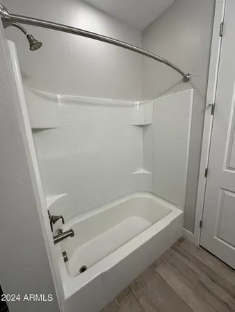 a bathroom with a tub and a shower