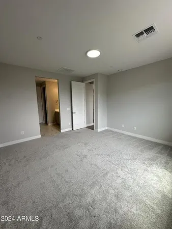 a view of an empty room and a window