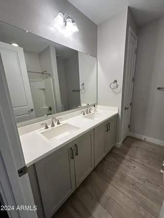 a spacious bathroom with a double vanity sink and mirror