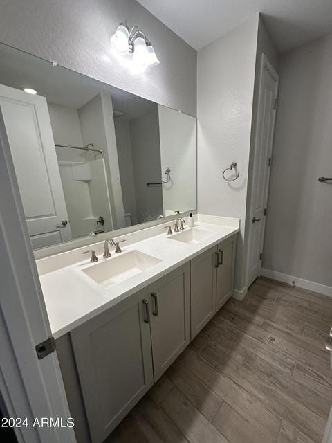 13209 West Roy Rogers Road Peoria, AZ 85383 - Photo 15 of 22 a spacious bathroom with a double vanity sink and mirror