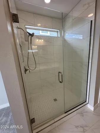 a bathroom with a glass shower door
