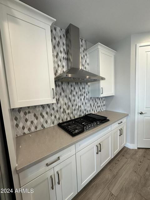 13209 West Roy Rogers Road Peoria, AZ 85383 - Photo 3 of 22 a kitchen with stainless steel appliances a stove and white cabinets