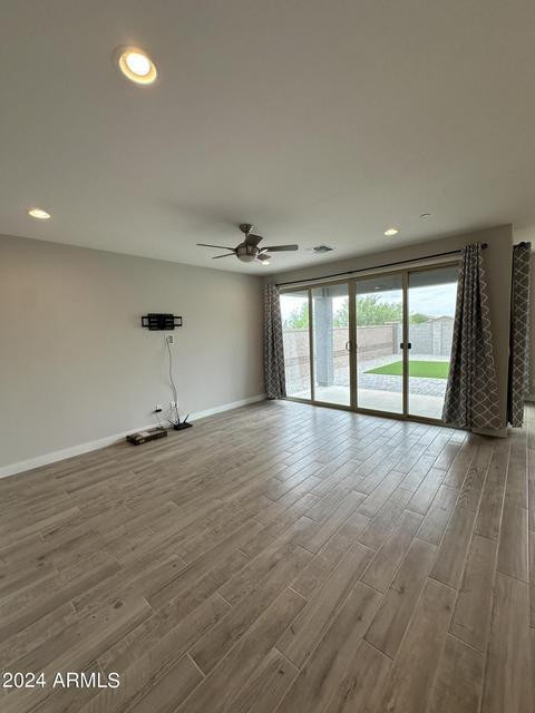 13209 West Roy Rogers Road Peoria, AZ 85383 - Photo 8 of 22 an empty room with wooden floor and windows