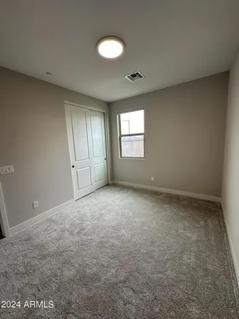 an empty room with a empty space and windows
