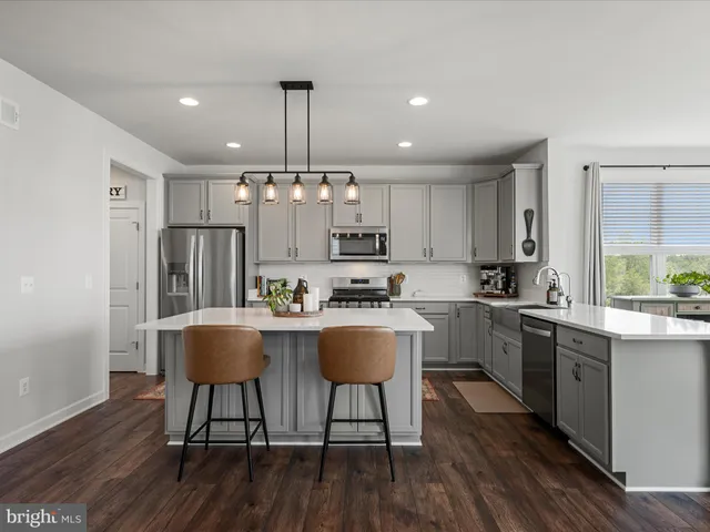 a view of a hallway with wooden floor and windows