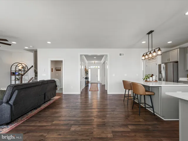 a spacious bedroom with a bed and a chandelier