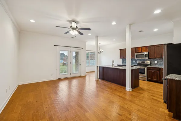 a large kitchen with stainless steel appliances kitchen island a large counter top and a stove top oven