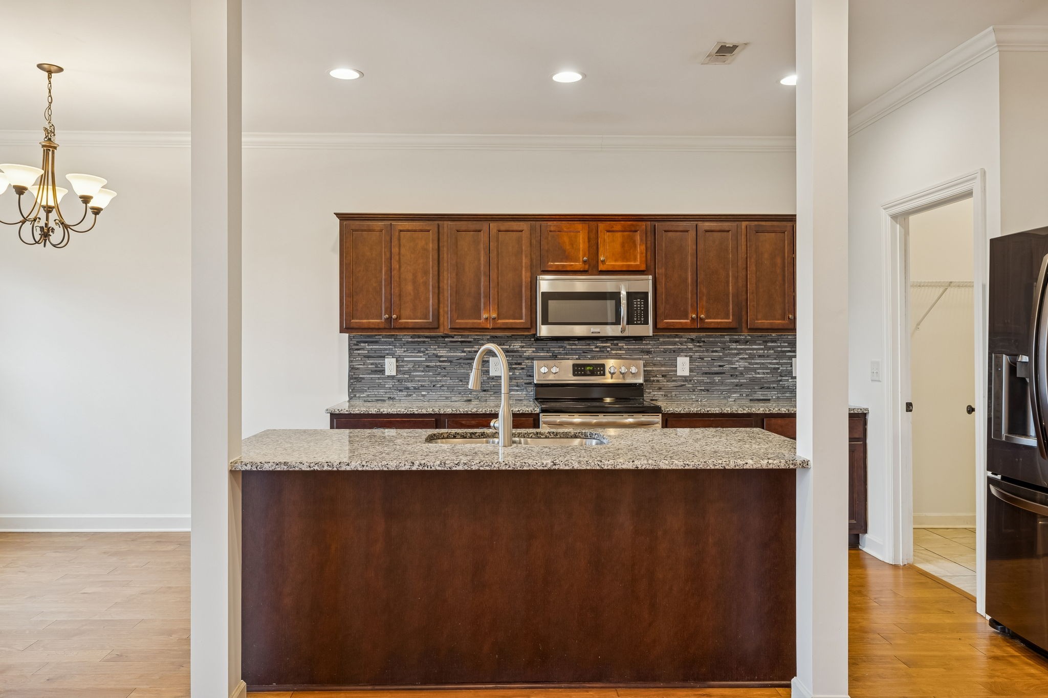 2912 Butterfly Bend Murfreesboro, TN 37129 - Photo 18 of 48 a kitchen with stainless steel appliances granite countertop a refrigerator a stove a sink and a microwave