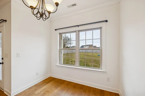 a view of a room with window and wooden floor