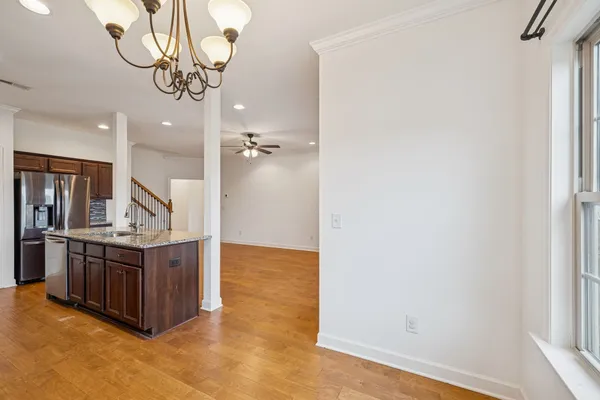 a view of a kitchen with stainless steel appliances granite countertop a refrigerator and a sink
