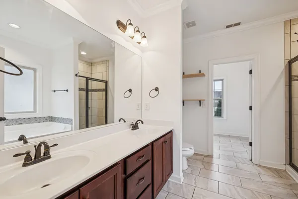 a bathroom with a sink double vanity and a mirror