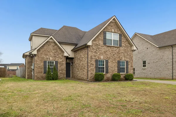 a front view of a house with a yard