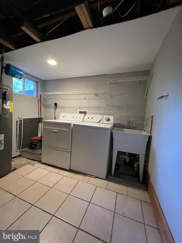 a kitchen with a sink a stove top oven and cabinets