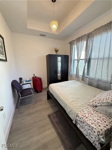 a bedroom with a bed dresser and a window