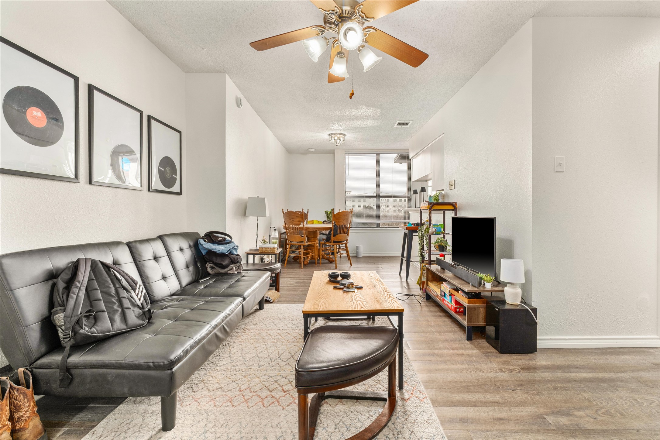 2409 Leon Street, Unit 307 Austin, TX 78705 - Photo 2 of 23 a living room with furniture and a flat screen tv